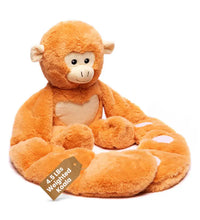 Weighted monkey stuffed animal hugger with white heart facing right 