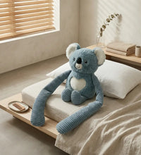 Weighted small koala hugger weighted koala plush animal on a bed