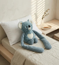 Weighted small koala hugger weighted koala stuffed animal in a cozy bedroom setting