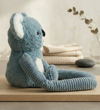 Weighted small koala hugger weighted koala stuffed animal sitting on a wooden surface
