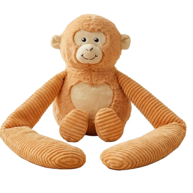 Weighted small monkey hugger toy sitting upright facing front on a white background