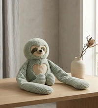 Weighted small sloth stuffed animal hugger sitting on a table