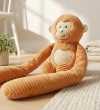 Weighted small monkey hugger weighted stuffed monkey sitting on a bed